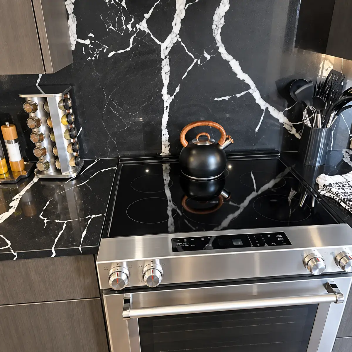 Clean stainless stove and polished black backsplash after turnover service.
